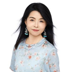 A person with long black hair wearing a floral shirt and earrings Description automatically generated